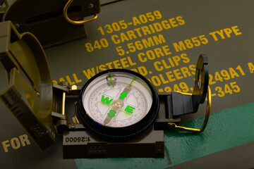 Original soldier compass on green army background , Soldier and outdoor equipment