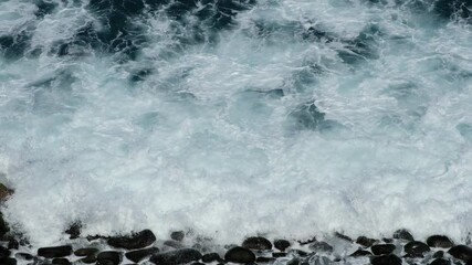 Wall Mural - ocean waves crashing on stones at beach