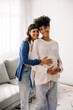 © (JLco) Julia Amaral - Expectant lesbian couple smiling at the camera
