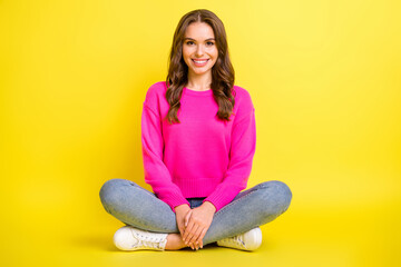 Poster - Full size photo of young happy positive good mood girl smiling sit floor with crossed legs isolated on yellow color background