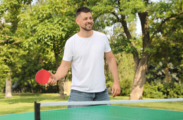 Sticker - Happy man playing ping pong outdoors on summer day