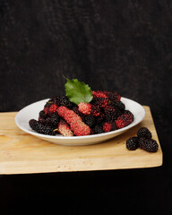 Wall Mural - Fresh blackberries contain lots of vitamin C. This blackish purple fruit has an equally sweet taste. Blackberries contain soluble and insoluble fiber which is good for digestive health. Focus blur.