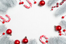 White Christmas Background With Christmas Tree Branches And Red Baubles