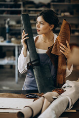 Wall Mural - Woman tailor working on leather fabric