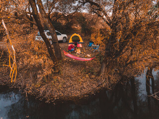 Wall Mural - couple resting near lake camping site