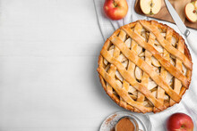 Delicious traditional apple pie on white table, flat lay. Space for text
