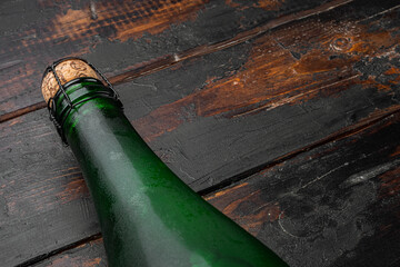 Green wine bottle, on old dark  wooden table background, with copy space for text