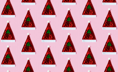 Seamless pattern with Santa Claus hat made of sequins on a pink background. Сoncept of holiday, Christmas and New Year