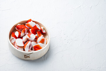 Wall Mural - Crab sticks seafood semi finished fish mince with blue swimming crab, on wooden tray, on white background  , with copyspace  and space for text