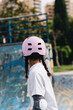 © ADDICTIVE STOCK - Cheerful African American woman in pink helmet and elbow pads