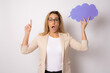 © Danko - Photo of shocked woman holding paper cloud pointing finger up isolated over white background