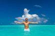 Leinwandbild Motiv Man snorkeling in clear tropical waters in front of exotic island