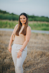 Poster - Vertical shot of a white Caucasian woman posing for a picture in the field