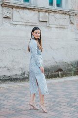 Poster - Vertical shot of a Caucasian female model posing in an elegant light blue dress blazer