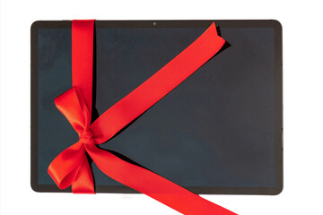 Wall Mural - digital tablet with red ribbon bow, christmas gift isolated on white. valentine, holiday present,