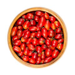 Wall Mural - Fresh wild rose hips in a wooden bowl. Also rose haw or rose hep. Ripe and intense red fruits, used for herbal teas, jam and can be eaten raw. One of the richest vitamin C sources available in plants.