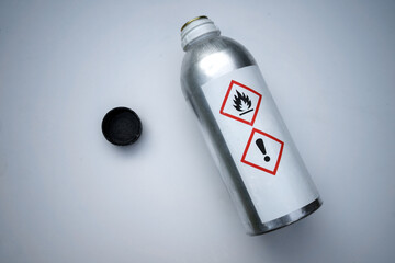 A metal bottle with a toxic substance on a white isolate. Glue for gluing organic glass. Chemical production. Harm to health and the environment.