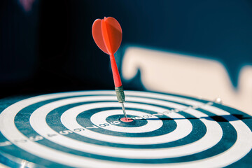 Bullseye or Bulls eye target or dartboard has dart arrow throw hitting the center of a shooting for financial business targeting planning and aim to winner goal of business concept.