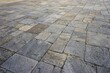 Slightly tilted view of broad ancient flagstone courtyard with variegated earth tones and assorted sizes architectural background pattern