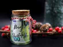 Euro Money Banknote In Christmas Jar With Text Merry Christmas On Black Background With Christmas Decoration