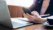 © Lek - E learning concept. Casual business woman using smartphone working or study online with laptop computer and lecture on notepad.