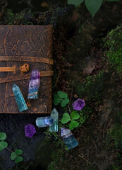 Poster - witches book and crystal minerals on dark natural background. Healing gemstones for Magic Crystal Ritual, Witchcraft, spiritual esoteric practice. top view