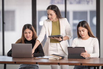 Poster - Horizontal shot of Asian females meeting with their tutor working with tablets and notebooks