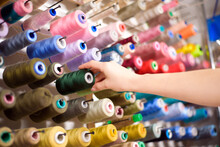 Colorful Cones And Spools Of Thread At An Atelier.Tailoring, Garment Industry, Designer Workshop Concept.