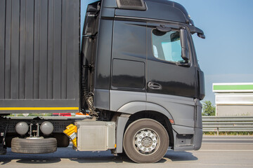 Canvas Print - euro truck with a container moves along the road