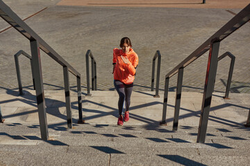 Sporty woman train exercise outdoors with devices