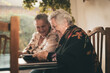 © ADDICTIVE STOCK - Aged women examining photos together