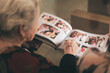 © ADDICTIVE STOCK - Old woman with photo album
