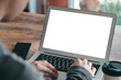 © Thapana_Studio - Mockup Copy Space Computer Notebook Laptop Concept , a man's hand using a laptop on internet websites at the office, keyboards on laptop computer with balnk copy screen for your advertising content.