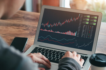 Businessmen work with stock market investments using laptops to analyze trading data. desktop computer with stock exchange graph on screen. Financial stock market. Analyzing data in office background.