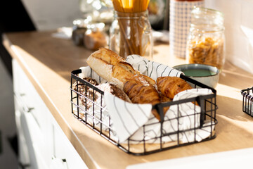 Aufkleber - Basket with various homemade baked goods, baguette, ciabatta and croissant on wooden kitchen table, copy space