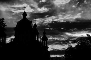 Religious church building silhouetted. Red majestic sky. Black and white image