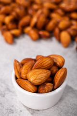 Wall Mural - Sweet almonds in a white bowl