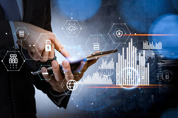 Businessman with tablet device, white hologram foreground with glowing information security icons and bar charts. Concept of cyber security and data storage. Padlock and business symbols.