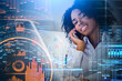 © ImageFlow - Black businesswoman talk on the phone in office room, financial analysis hud