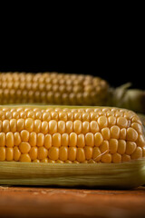 Sticker - Fresh corn cobs on a black background