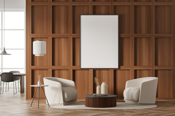 Empty canvas on wood wall of living room with two beige armchairs