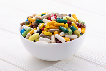 Wall Mural - Plate full of colored pills and medical capsule