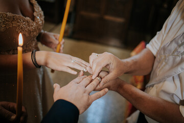 Poster - Man holding the hand o bride and groom during a wedding ceremony