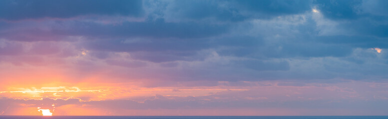 Wall Mural - Natural background, stunning view of a dramatic, cloudy sunrise. Romantic sky, copy space, sky replacement, Sardinia, Italy.