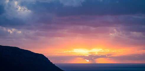 Wall Mural - Natural background, stunning view of a dramatic, cloudy sunrise. Romantic sky, copy space, sky replacement, Sardinia, Italy.