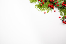 Christmas Holidays Composition With Christmas Decorations, Red Berries And Thuja Branches On White Background With Copy Space, Top View