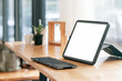 © NAMPIX - Mockup portable blank screen tablet and keyboard on wooden table with  copy space.