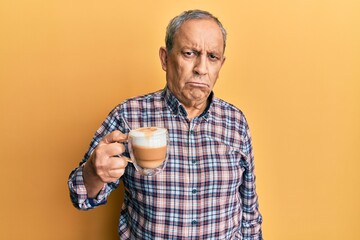 Sticker - Handsome senior man with grey hair drinking a cup coffee depressed and worry for distress, crying angry and afraid. sad expression.