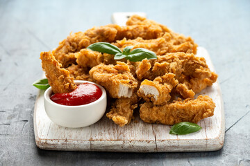 Fried Chicken strips with ketchup on white wooden board. Fast Food