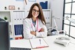© Krakenimages.com - Young doctor woman wearing doctor uniform and stethoscope at the clinic happy face smiling with crossed arms looking at the camera. positive person.